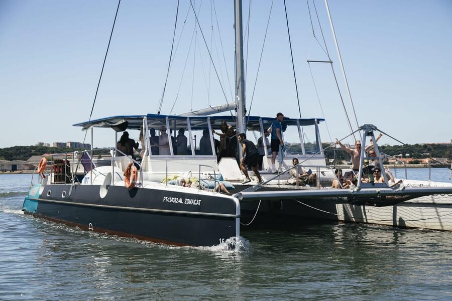 Lisbon: Catamaran Boat Party with Music, Open Bar & Dives - Algés: where the cruise finds its easy rhythm