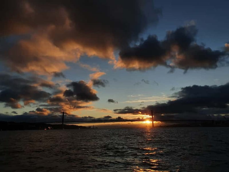 Lisbon: Sunset Catamaran Cruise with Drinks - Monument to the Discoveries and Champalimaud: river lights for the final act