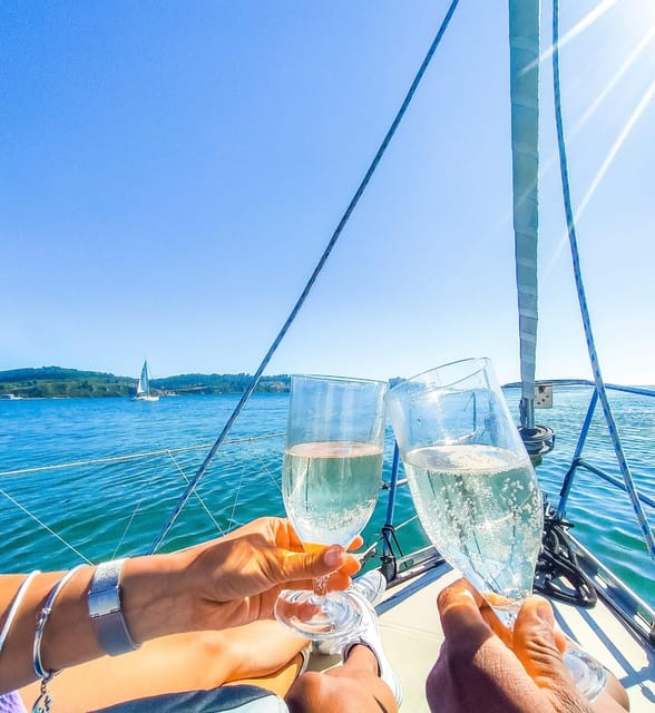 Lisbon: "Sunset" & "Day Tours" by boat, with drink and music - Sunset sailing with wine, Bluetooth music, and blankets when it cools