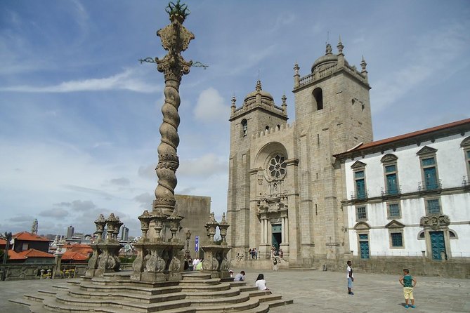 Porto Full Day City Tour Wine Tasting and Six Bridges Cruise - The medieval core walk, then Clérigos baroque and big stair energy