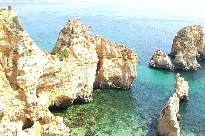 Private Algarve: Benagil Caves, Lagos Cliffs & Hidden Beaches - Praia dos Estudantes: the cliff tunnel, the bridge, and sheltered swimming