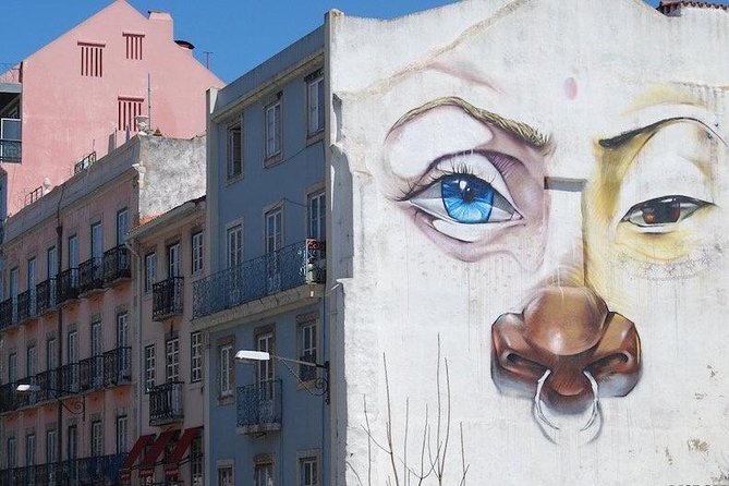 Tuk Tuk Lisbon: Exploring Urban Art - Vhils in Travessa das Merceeiras, face carved from the street